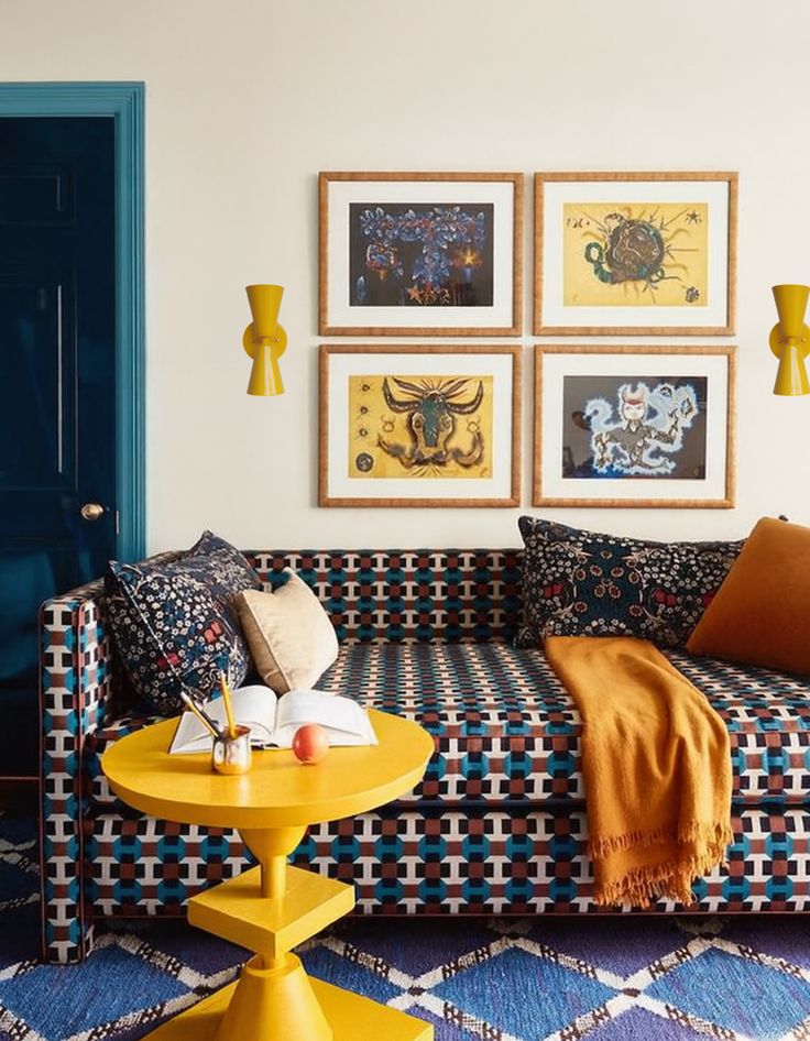Blue and red geometric sofa making a statement under a gallery wall