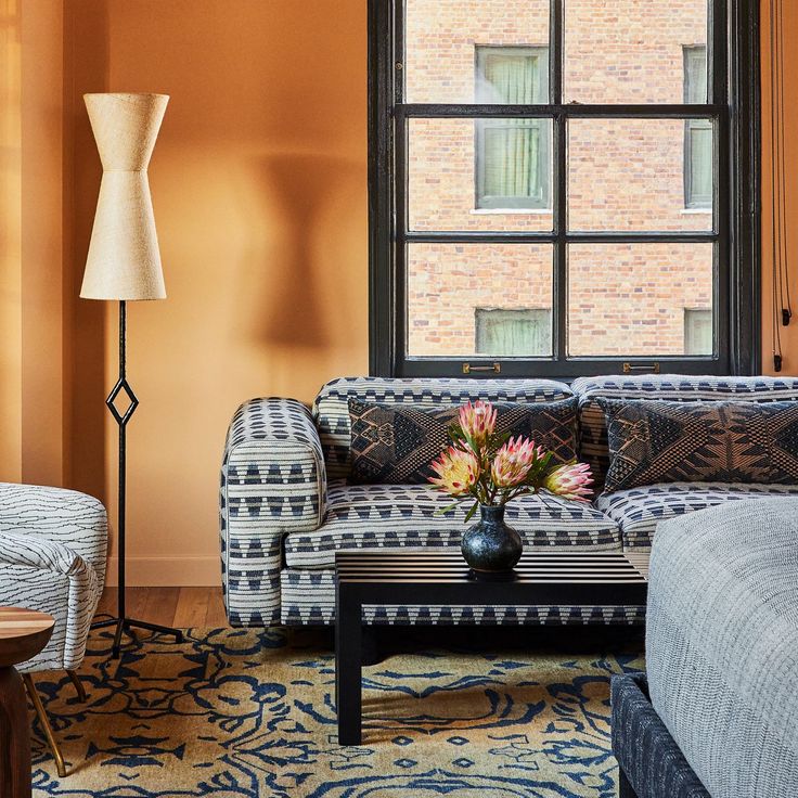 Blue geometric sofa placed on patterned rug