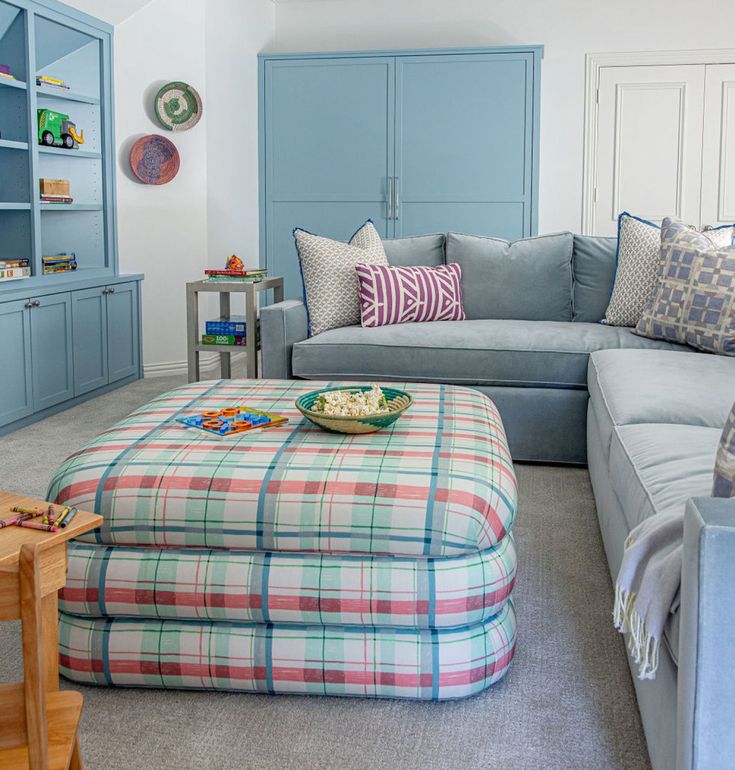Plaid ottoman introducing color and pattern into living room
